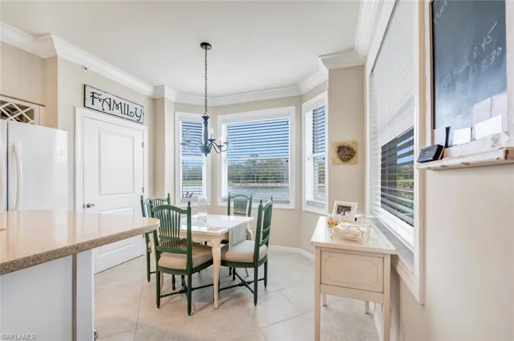 Dining area with a chandelier, crown molding, and light tile patterned floors