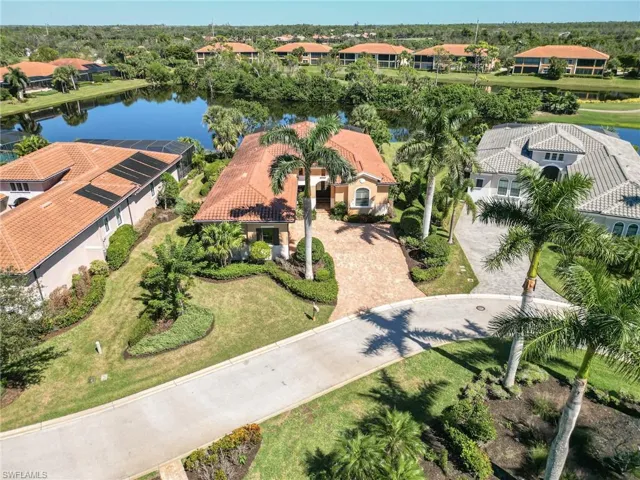 Drone / aerial view of a front of the house overlooking water and preserve area.