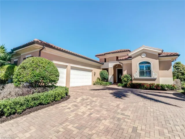 Mediterranean / spanish-style home with decorative driveway, an attached garage, stucco siding, and a tiled roof