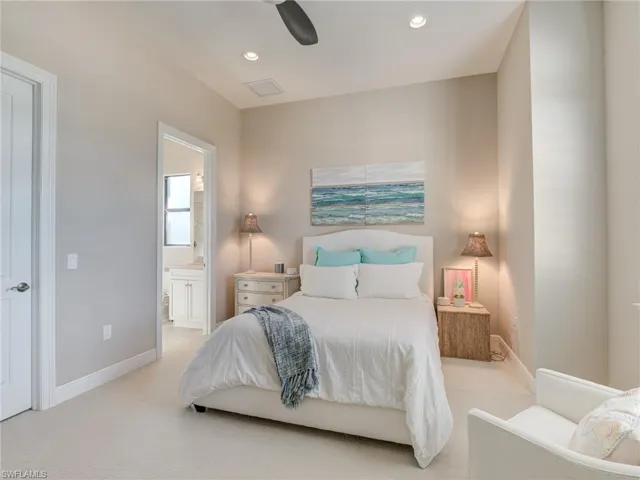 Carpeted bedroom with recessed lighting, ensuite bathroom, and ceiling fan