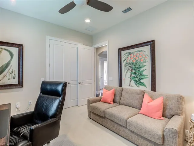 Carpeted office featuring closet, a ceiling fan, and recessed lighting