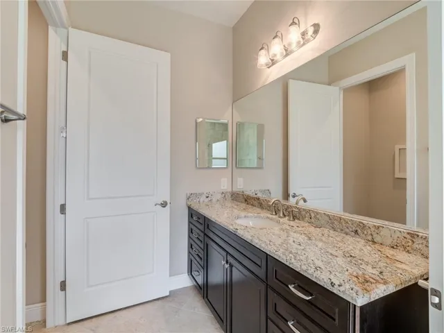 Bathroom with vanity and light tile patterned flooring