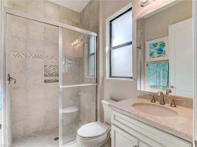 En suite bathroom featuring vanity and a stall shower