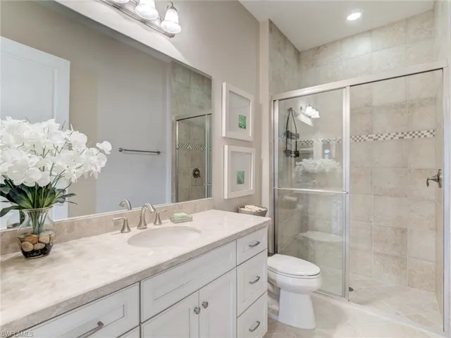 Fourth Full bathroom with vanity, a shower stall, and light tile patterned floors