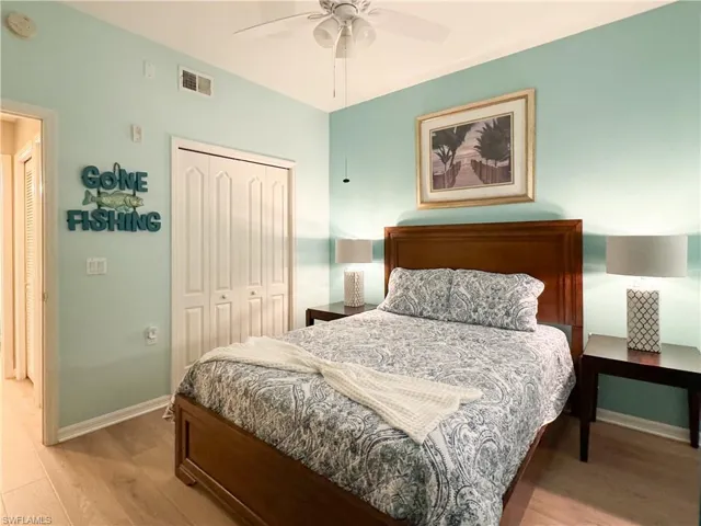 Bedroom featuring ceiling fan, a closet, and hardwood / wood-style flooring
