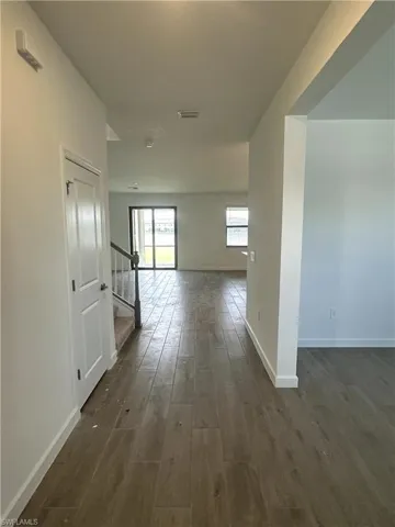 Corridor featuring dark wood-type flooring
