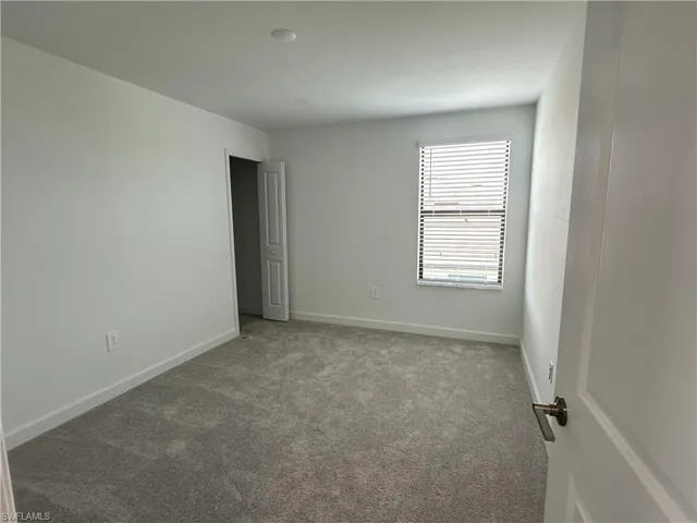 Unfurnished room with carpet flooring