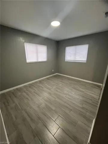 Unfurnished room with hardwood / wood-style flooring