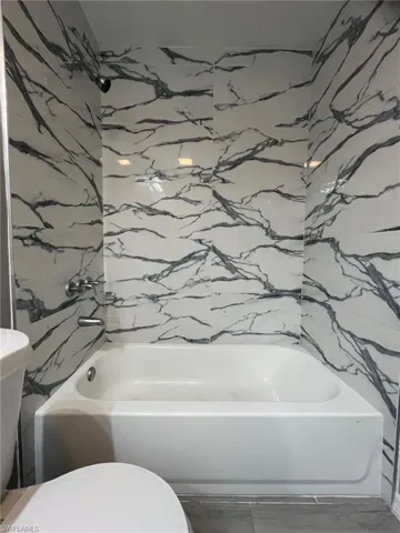 Bathroom with tile patterned floors and toilet