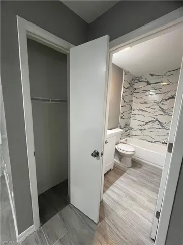 Bathroom featuring vanity, wood-type flooring, and toilet