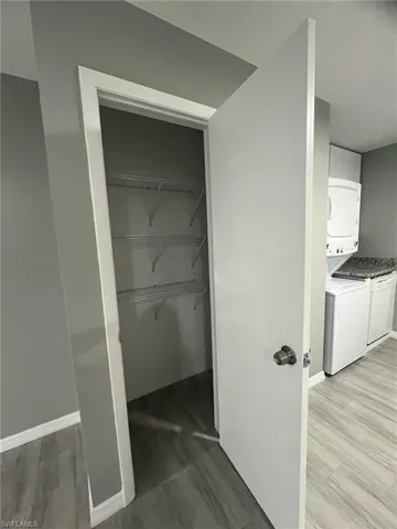 Closet featuring stacked washing maching and dryer