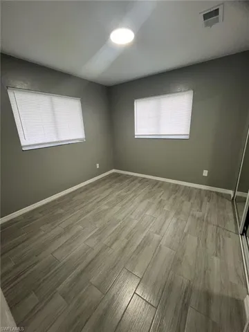 Spare room featuring wood-type flooring