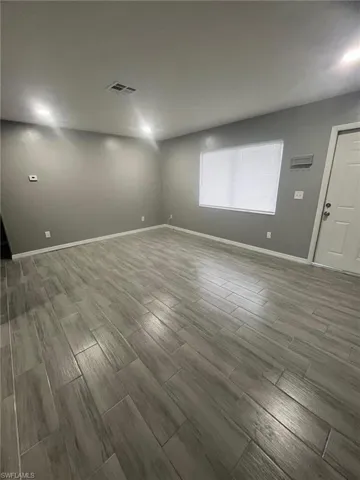 Unfurnished room with hardwood / wood-style flooring