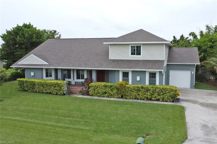 View of front of house featuring a garage and a front yard