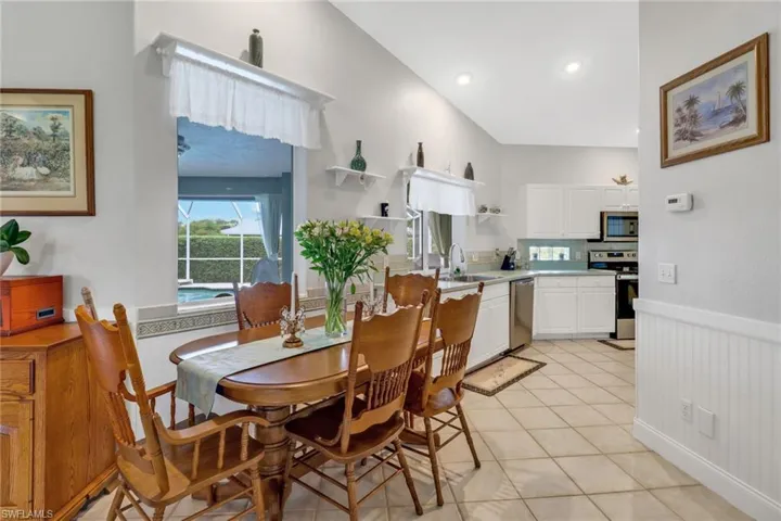 Tiled dining area featuring sink