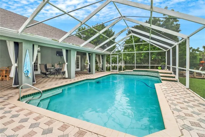 View of swimming pool featuring a patio and a lanai