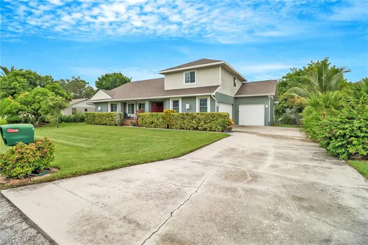 View of front of property featuring a garage and a front yard