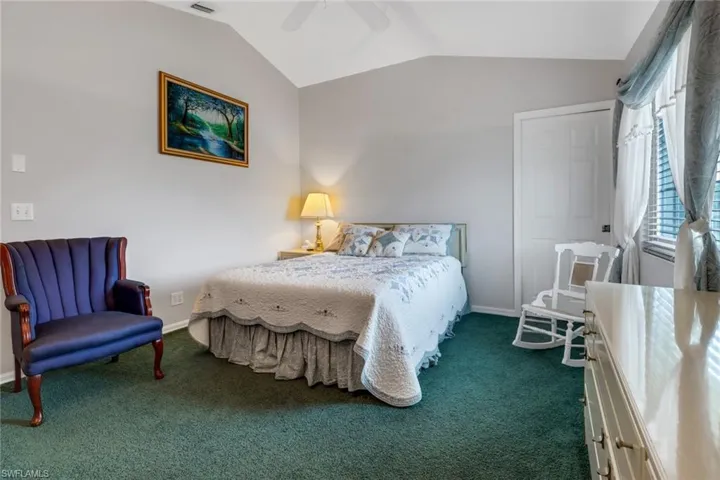 Bedroom featuring carpet flooring, lofted ceiling, and ceiling fan