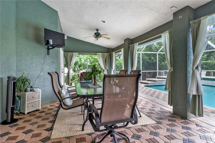 Sunroom featuring vaulted ceiling and ceiling fan