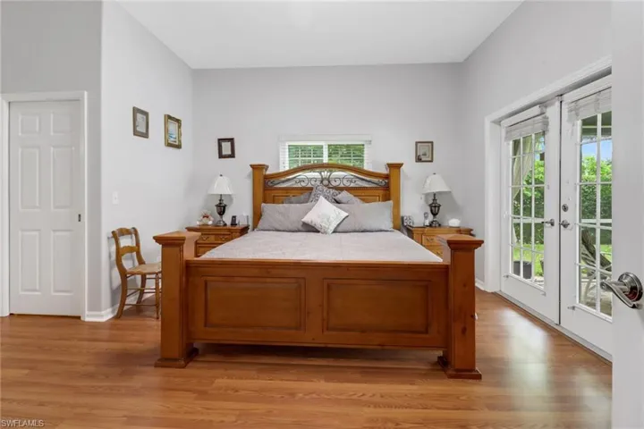 Bedroom with hardwood / wood-style flooring, access to outside, and french doors