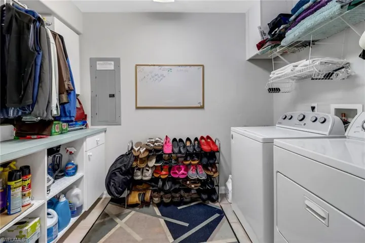 Laundry room featuring washing machine and dryer and electric panel