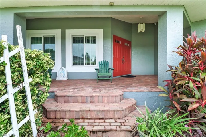 View of exterior entry with a porch
