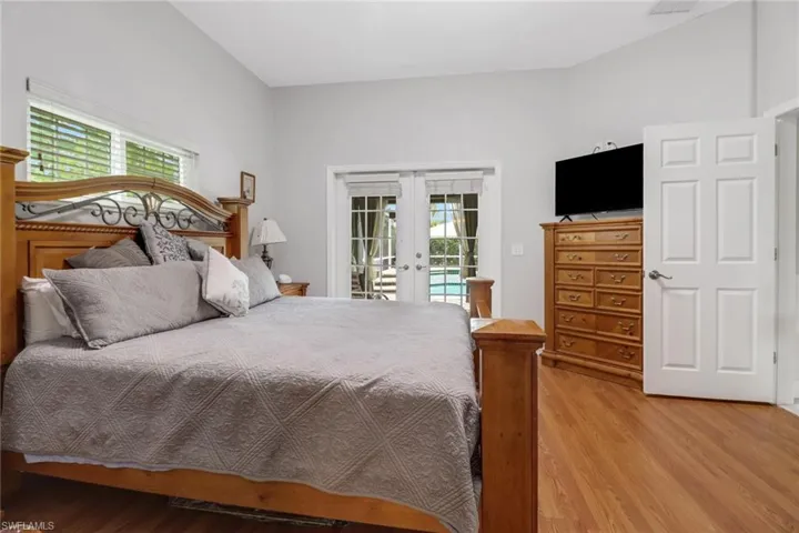 Bedroom featuring access to exterior, light wood-type flooring, and french doors