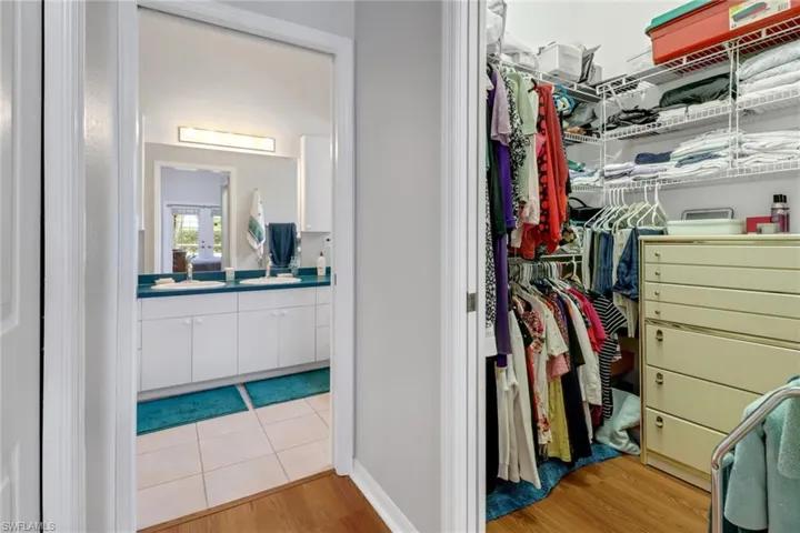 Walk in closet featuring sink and light wood-type flooring