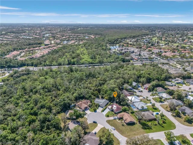 Aerial view with a residential view and a wooded view
