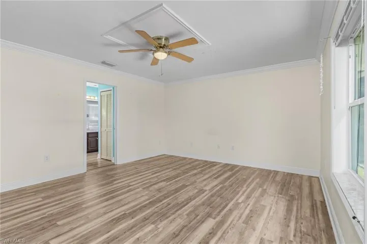BR 1 featuring visible vents, crown molding, and light wood-style flooring