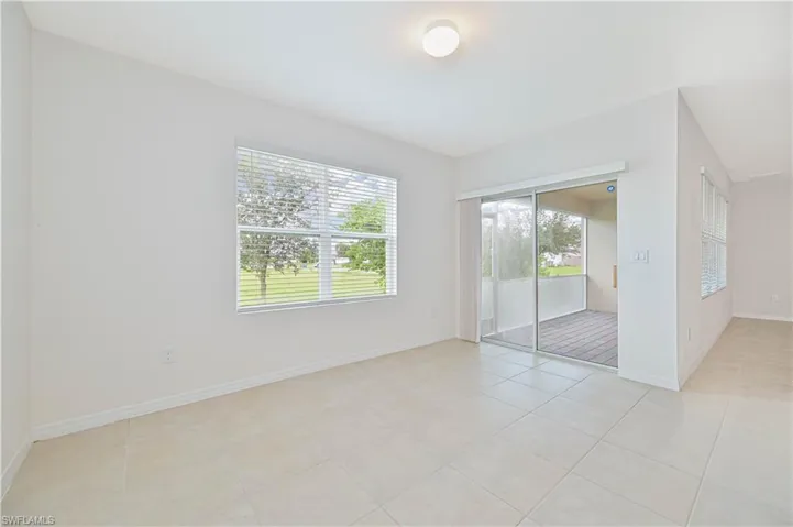 Empty room with baseboards and light tile patterned floors