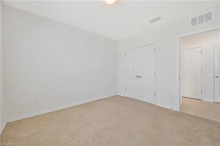 Unfurnished bedroom featuring carpet and a closet