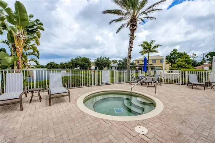View of swimming pool with a hot tub and patio surround