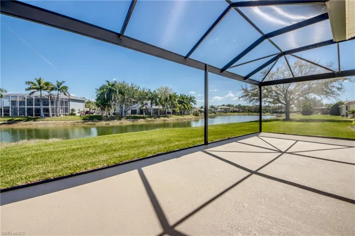 View of patio / terrace with a water view, glass enclosure, a sunroom, and a residential view