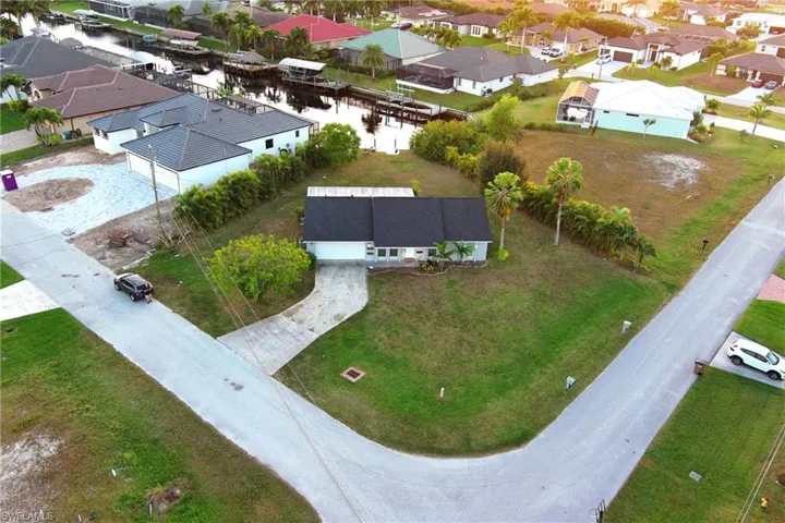 Aerial perspective of suburban area featuring a large body of water