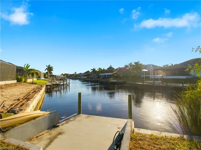 Dock area with a water view and a residential view