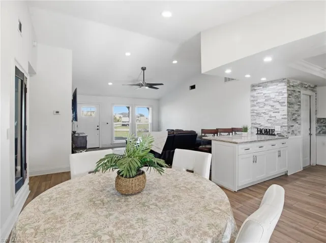 Dining space featuring lofted ceiling, a ceiling fan, recessed lighting, and light wood-type flooring