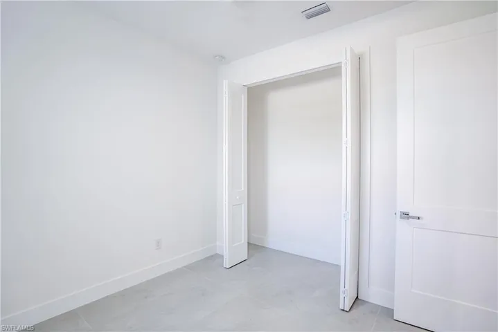 Unfurnished bedroom with baseboards and a closet