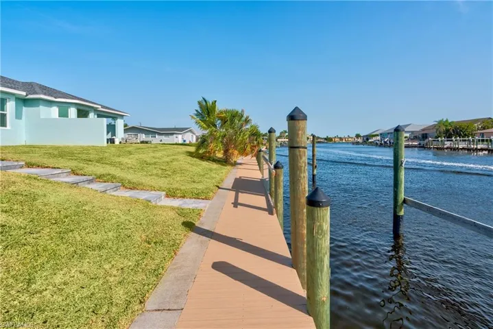 Dock area featuring a yard, a water view, and a residential view