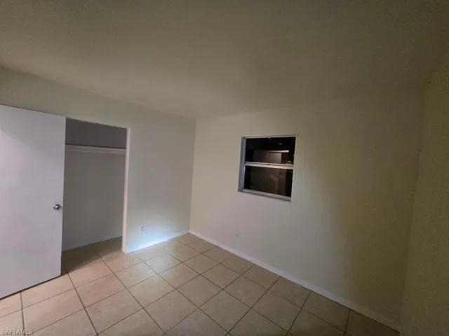 Unfurnished bedroom featuring a closet and light tile patterned floors