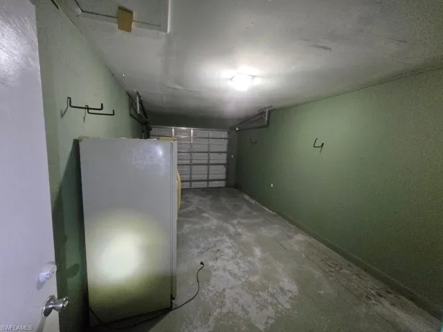 Garage featuring freestanding refrigerator