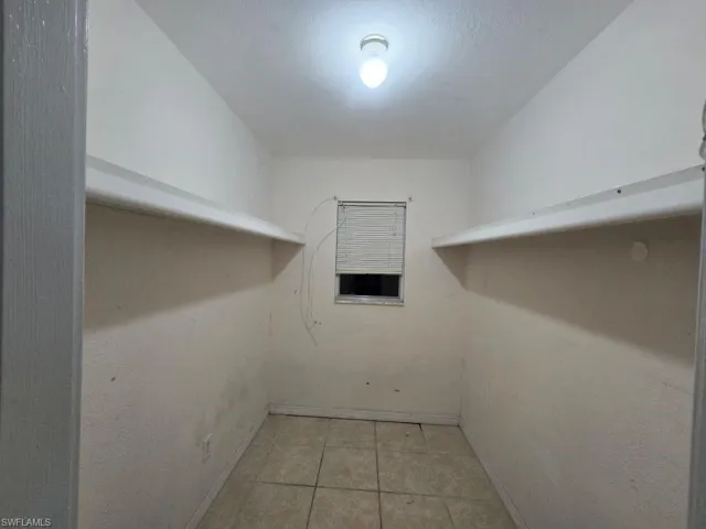 Walk in closet featuring light tile patterned floors