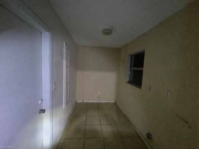 Hallway with light tile patterned flooring