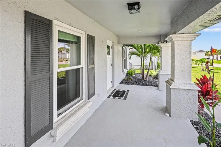 Wide covered front porch ideal for lounging, rocking chairs