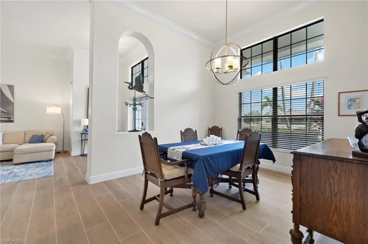 Dining room with a notable chandelier and ornamental molding