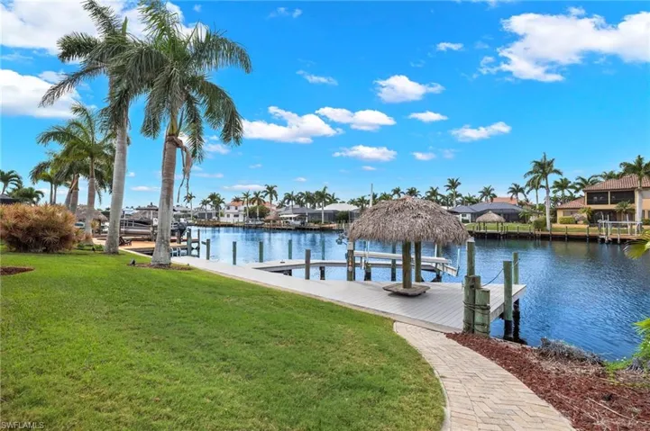 View of dock featuring a water view and a yard