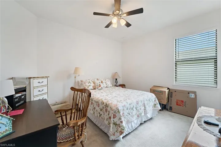 Bedroom with carpet floors and a ceiling fan