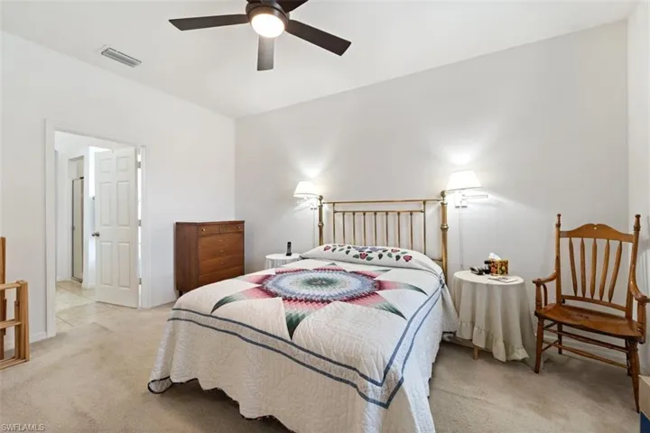 Bedroom featuring light carpet and a ceiling fan