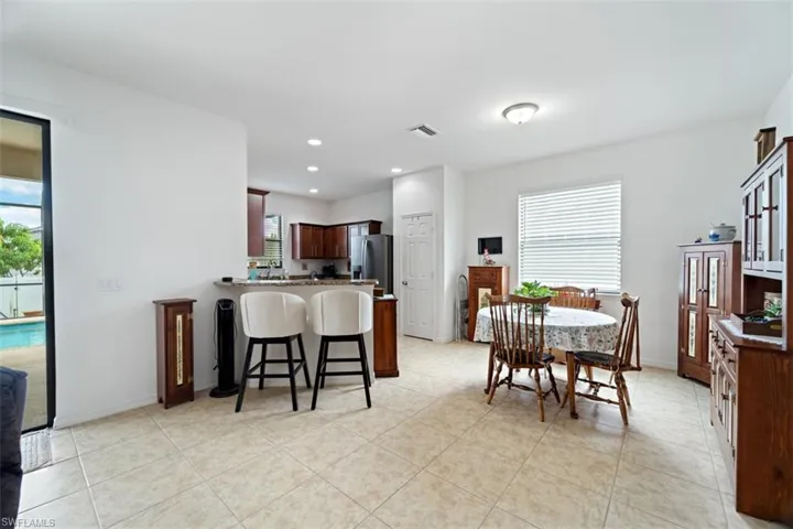 Dining space featuring healthy amount of natural light, recessed lighting, and light tile patterned flooring