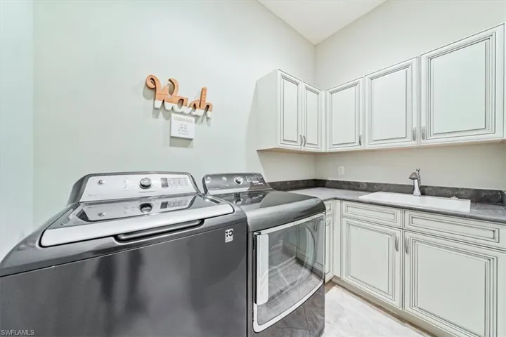 Laundry with Cabinets and Utility Sink